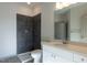 Modern bathroom with tiled walk-in shower, sleek fixtures, and white vanity, offering a clean aesthetic at 2300 Gathering Sq Ct, Fuquay Varina, NC 27526