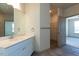 Bright bathroom with a white vanity, large mirror, and access to a walk-in closet and bedroom at 2300 Gathering Sq Ct, Fuquay Varina, NC 27526