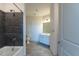 Modern bathroom featuring a tiled shower with sleek fixtures, light tile floor, and a white vanity at 2300 Gathering Sq Ct, Fuquay Varina, NC 27526