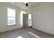 Carpeted bedroom featuring two windows providing lots of natural light and a neutral color palette at 2300 Gathering Sq Ct, Fuquay Varina, NC 27526