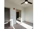 Spacious bedroom features neutral carpet, a ceiling fan, and doorways to closet and bathroom at 2300 Gathering Sq Ct, Fuquay Varina, NC 27526
