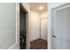 Hallway with gray trim, wood floors, and access to a storage closet at 2300 Gathering Sq Ct, Fuquay Varina, NC 27526