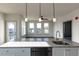 Modern kitchen features a large island, granite counters, stainless appliances, and open concept living at 2300 Gathering Sq Ct, Fuquay Varina, NC 27526