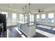Modern kitchen features a large island, granite counters, stainless appliances, and lots of windows at 2300 Gathering Sq Ct, Fuquay Varina, NC 27526