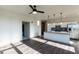 Open-concept living area with a modern kitchen featuring stainless steel appliances, white cabinets, and pendant lighting at 2300 Gathering Sq Ct, Fuquay Varina, NC 27526