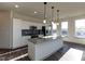 Modern kitchen boasts granite countertops, stainless appliances, and white cabinetry at 2300 Gathering Sq Ct, Fuquay Varina, NC 27526