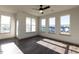 Bright living room with ample windows and dark hardwood floors at 2300 Gathering Sq Ct, Fuquay Varina, NC 27526