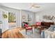 Bright living room with wood floors, comfortable seating, and a view of the front yard at 2407 Cascadilla St, Durham, NC 27704