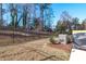 Expansive backyard with trees, privacy fence, and an air conditioning unit at 2440 Tonoloway Dr, Raleigh, NC 27610