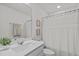 Clean bathroom with a vanity, framed art, and a shower-tub combo with a decorative curtain at 2440 Tonoloway Dr, Raleigh, NC 27610