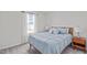 A cozy bedroom featuring a large bed, side tables, and plush carpet flooring at 2440 Tonoloway Dr, Raleigh, NC 27610