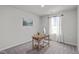 Bright bedroom featuring gray carpet, natural light, and a wooden desk creating a comfortable workspace at 2440 Tonoloway Dr, Raleigh, NC 27610