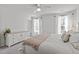 A bright bedroom featuring a large bed, dresser, and plush carpet flooring at 2440 Tonoloway Dr, Raleigh, NC 27610