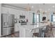 Modern kitchen with island, stainless appliances, and eat-in counter seating at 2440 Tonoloway Dr, Raleigh, NC 27610