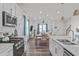 Bright kitchen flows to dining and living areas, showcasing stainless appliances and wood floors at 2440 Tonoloway Dr, Raleigh, NC 27610