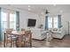 Inviting living room with a large TV, comfortable seating, and a dining area at 2440 Tonoloway Dr, Raleigh, NC 27610