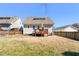 Home's backyard with fence, wooden deck, and mature tree at 2715 Edmund St, Durham, NC 27705