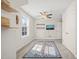 Bright carpeted bedroom with ceiling fan, closet, mounted TV, and two windows at 2715 Edmund St, Durham, NC 27705