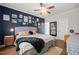 Cozy bedroom with a gallery wall, hardwood floors, and abundant natural light at 2715 Edmund St, Durham, NC 27705