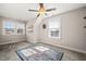 Bright bedroom with carpeted floor, ceiling fan, and two windows at 2715 Edmund St, Durham, NC 27705