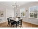 Bright dining room featuring hardwood floors, black table and chairs, and natural light at 2715 Edmund St, Durham, NC 27705