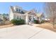Home with a welcoming front porch, shingle detailing, and manicured landscaping and spacious driveway at 2715 Edmund St, Durham, NC 27705