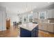 Bright kitchen with stainless steel appliances, kitchen island, and hardwood floors at 2715 Edmund St, Durham, NC 27705