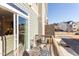 Balcony with outdoor seating, a small table, and sliding glass door access to the living area at 2929 Great Lawn Rd, Apex, NC 27502