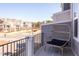 Balcony with a chair overlooking the charming neighborhood and tree-lined streets at 2929 Great Lawn Rd, Apex, NC 27502