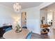Dining room with a chandelier, round table, blue chairs, and a colorful rug at 2929 Great Lawn Rd, Apex, NC 27502