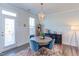 Dining room with a chandelier, round table, blue chairs, and a colorful rug at 2929 Great Lawn Rd, Apex, NC 27502