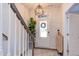 Inviting entryway with stylish lighting, plant decor and front door, offering a warm welcome and a glimpse of modern design at 2929 Great Lawn Rd, Apex, NC 27502