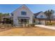 Beautiful white farmhouse-style building with a metal roof, manicured landscaping, and covered porch at 2929 Great Lawn Rd, Apex, NC 27502