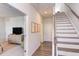 Bright hallway with staircase leading to upper levels, showcasing modern design and seamless transition to living spaces at 2929 Great Lawn Rd, Apex, NC 27502