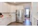 Bright kitchen features stainless steel appliances, white cabinets, countertops and backsplash at 2929 Great Lawn Rd, Apex, NC 27502