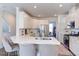 Modern kitchen with a large island, white cabinets, stainless steel appliances, and seating for four at 2929 Great Lawn Rd, Apex, NC 27502