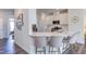 Modern kitchen with a center island, white cabinets, stainless steel appliances, and barstool seating at 2929 Great Lawn Rd, Apex, NC 27502