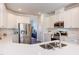 The kitchen is bright and features white cabinets, countertops and a stainless steel refrigerator at 2929 Great Lawn Rd, Apex, NC 27502