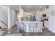 Modern kitchen with white cabinets, stainless steel appliances, and bar seating at the island at 2929 Great Lawn Rd, Apex, NC 27502