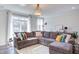Bright and inviting living room featuring a large sectional sofa and lots of natural light at 2929 Great Lawn Rd, Apex, NC 27502