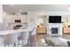 Stylish living room with modern kitchen, fireplace, and elegant decor, perfect for comfortable living and entertaining at 2929 Great Lawn Rd, Apex, NC 27502