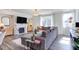 Cozy living room featuring a fireplace, large sectional sofa, and bright natural light at 2929 Great Lawn Rd, Apex, NC 27502