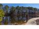 Scenic pond with a walking path surrounded by lush trees, creating a peaceful natural setting at 2929 Great Lawn Rd, Apex, NC 27502