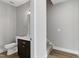 Modern half bath featuring a vanity with storage and a toilet, with stairway in the background at 3010 Garner Rd # 102, Raleigh, NC 27610