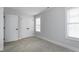 Light, bright bedroom with plush carpet, a window with blinds, and a closet at 3010 Garner Rd # 102, Raleigh, NC 27610