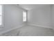 Empty bedroom featuring neutral carpet, freshly painted walls and a window with blinds at 3010 Garner Rd # 102, Raleigh, NC 27610