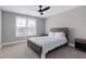 Inviting bedroom with neutral walls, ceiling fan, carpeted floors, and a bright window with blinds at 3010 Garner Rd # 102, Raleigh, NC 27610