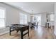 Bright dining area with a foosball table and adjacent kitchen featuring a modern design at 3010 Garner Rd # 102, Raleigh, NC 27610