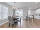Cozy dining area with a modern chandelier, kitchen access, and bright natural light at 3010 Garner Rd # 102, Raleigh, NC 27610