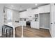 Bright kitchen featuring white cabinets, stainless steel appliances, an island with seating, and stylish backsplash at 3010 Garner Rd # 102, Raleigh, NC 27610